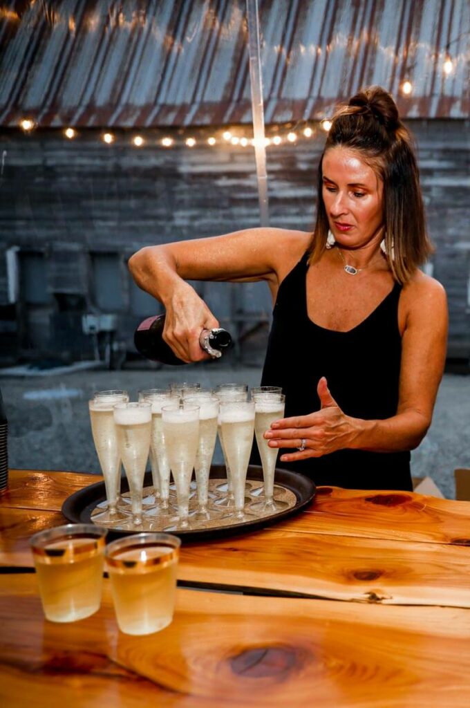 Champagne toasts with barn background