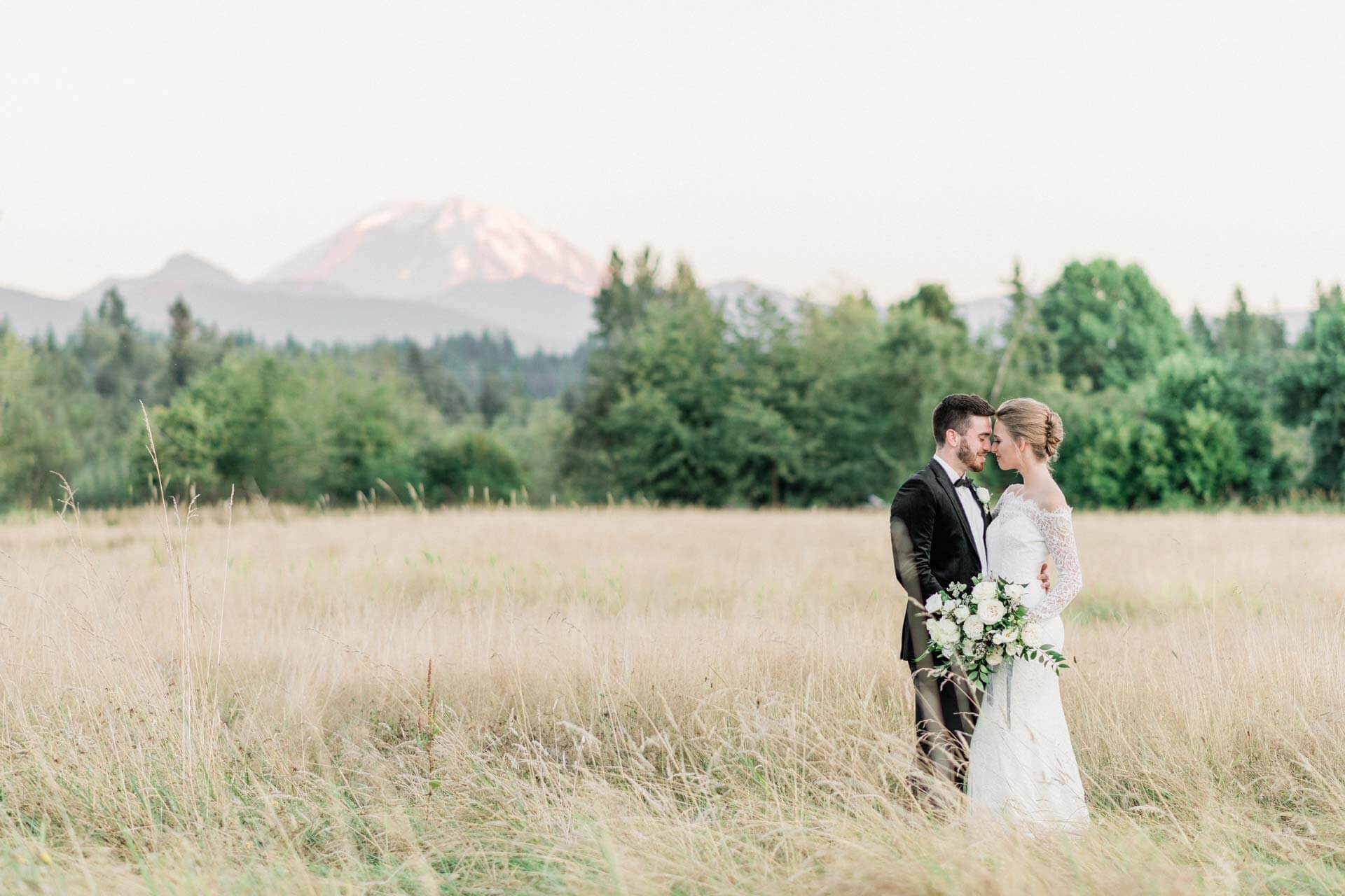 French Countryside Wedding Inspiration Bride and Groom in hayfield with Mount Rainier View