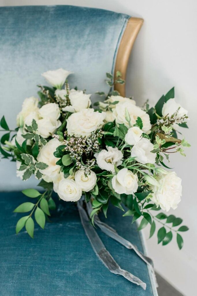 french countryside wedding inspiration vintage blue velvet chair with bridal bouquet