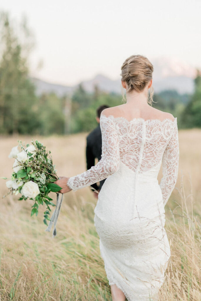 French Countryside Wedding Inspiration back of bride walking in field