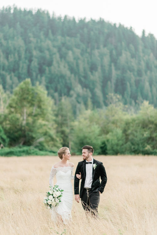 French Countryside Wedding Inspiration Bride and Groom walking in hayfield