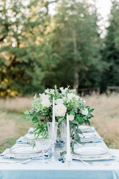French Countryside Wedding Inspiration reception table in field with trees