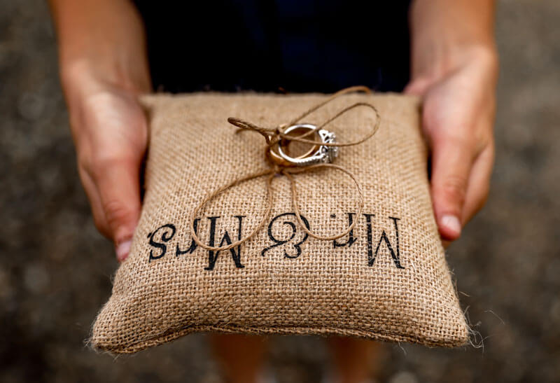 Wedding rings on burlap pillow