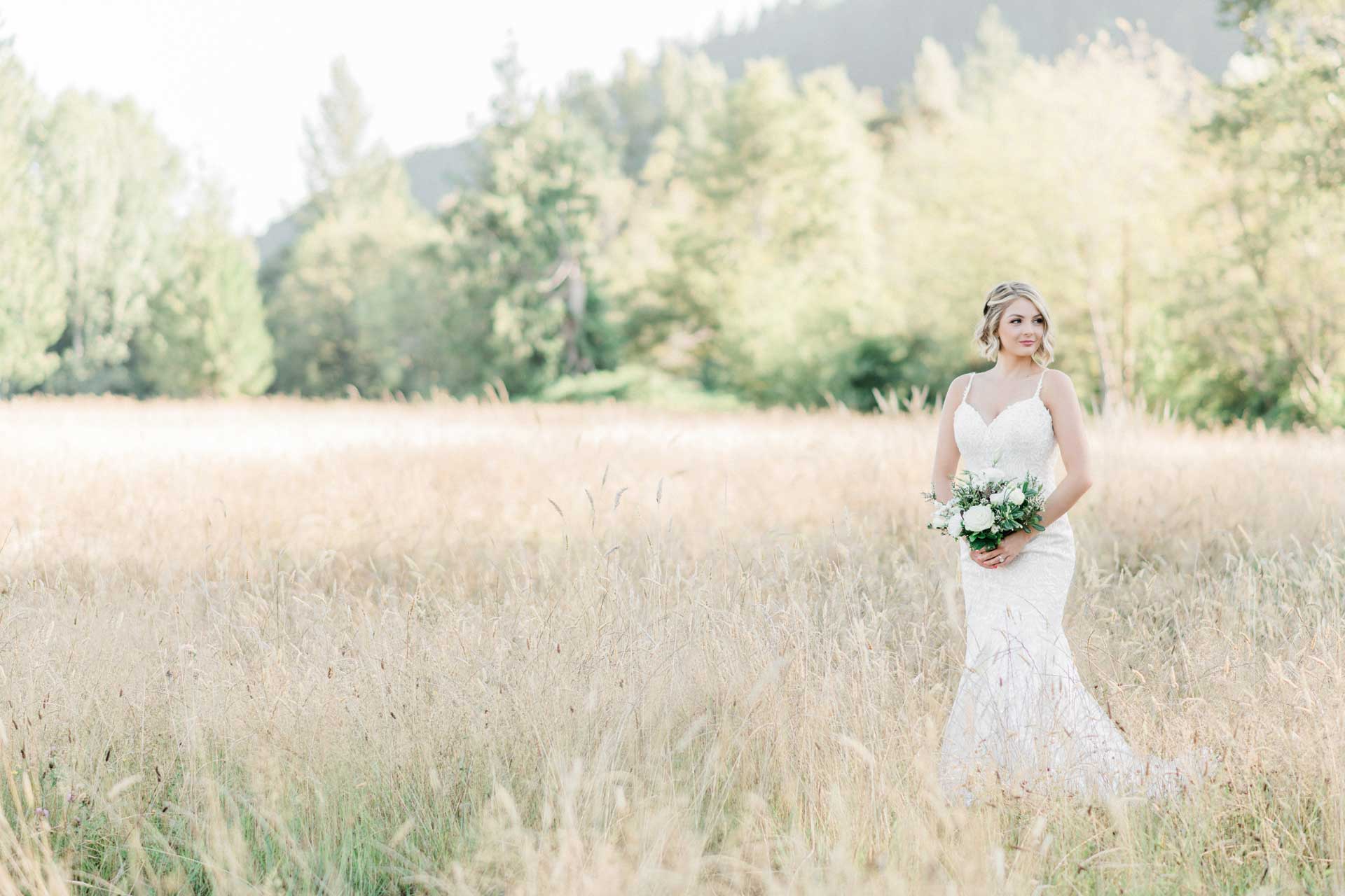 Romantic blush wedding bride in hayfield at Mount Peak Farm