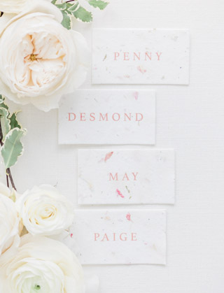 Romantic blush wedding place cards with flowers
