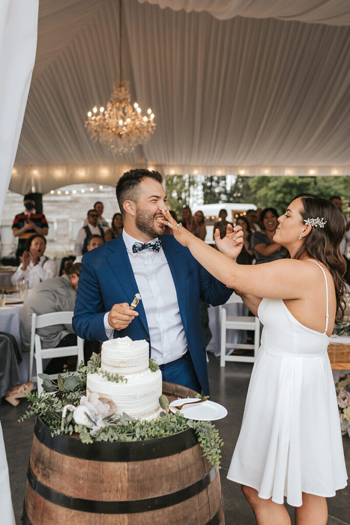 Bride and Groom smashing cake at Mount Peak Farm