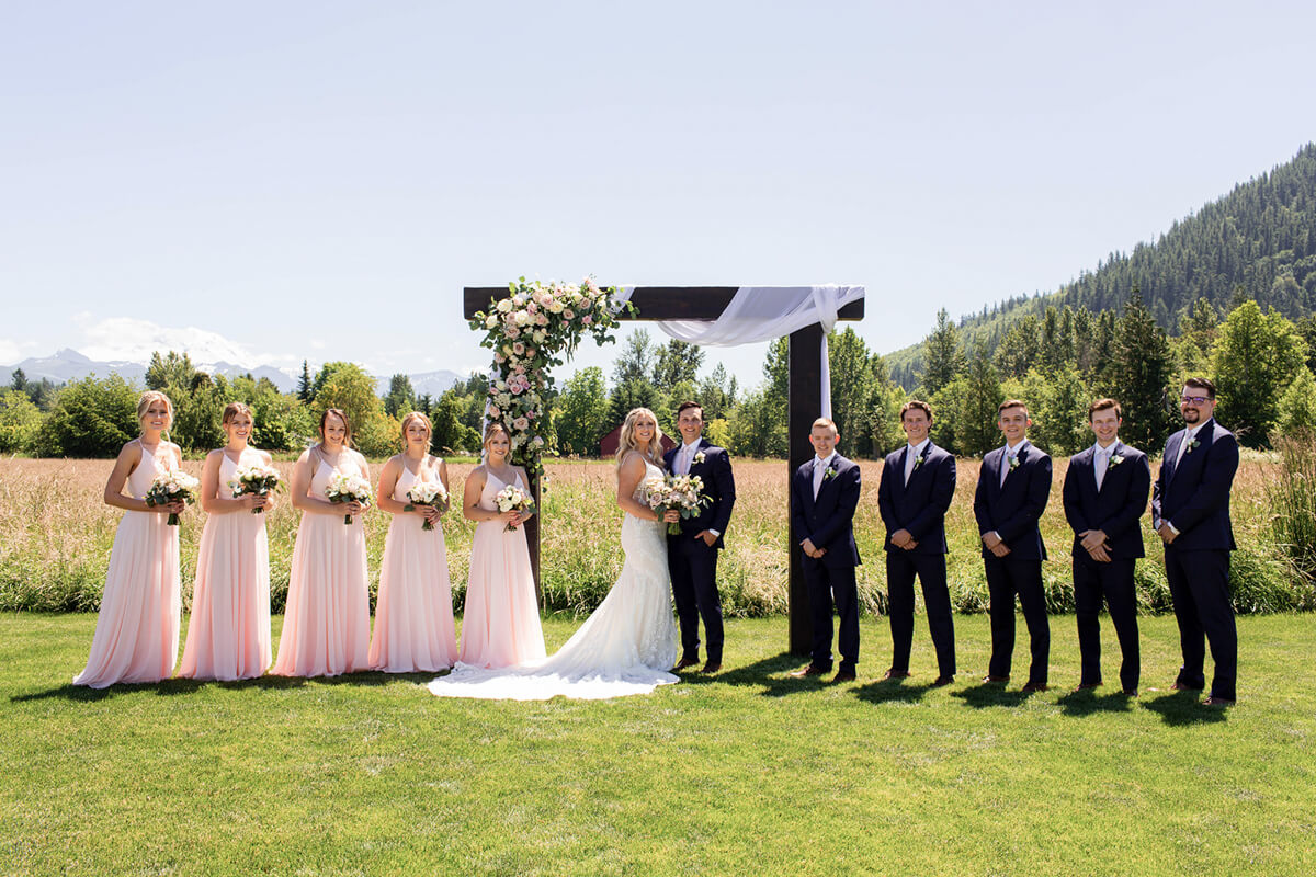 Beautiful Blush Wedding Party with Arbor