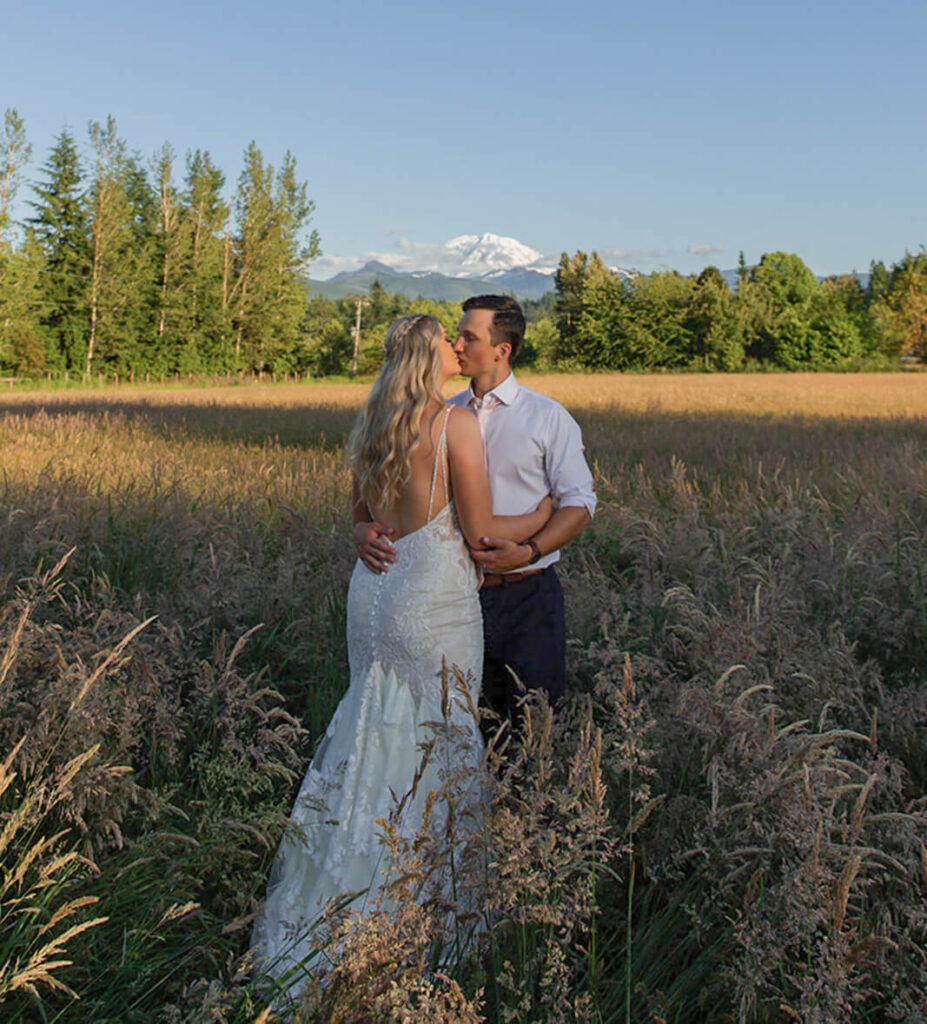 Bride and groom kissing with Mount Rainier view at Mount Peak Farm