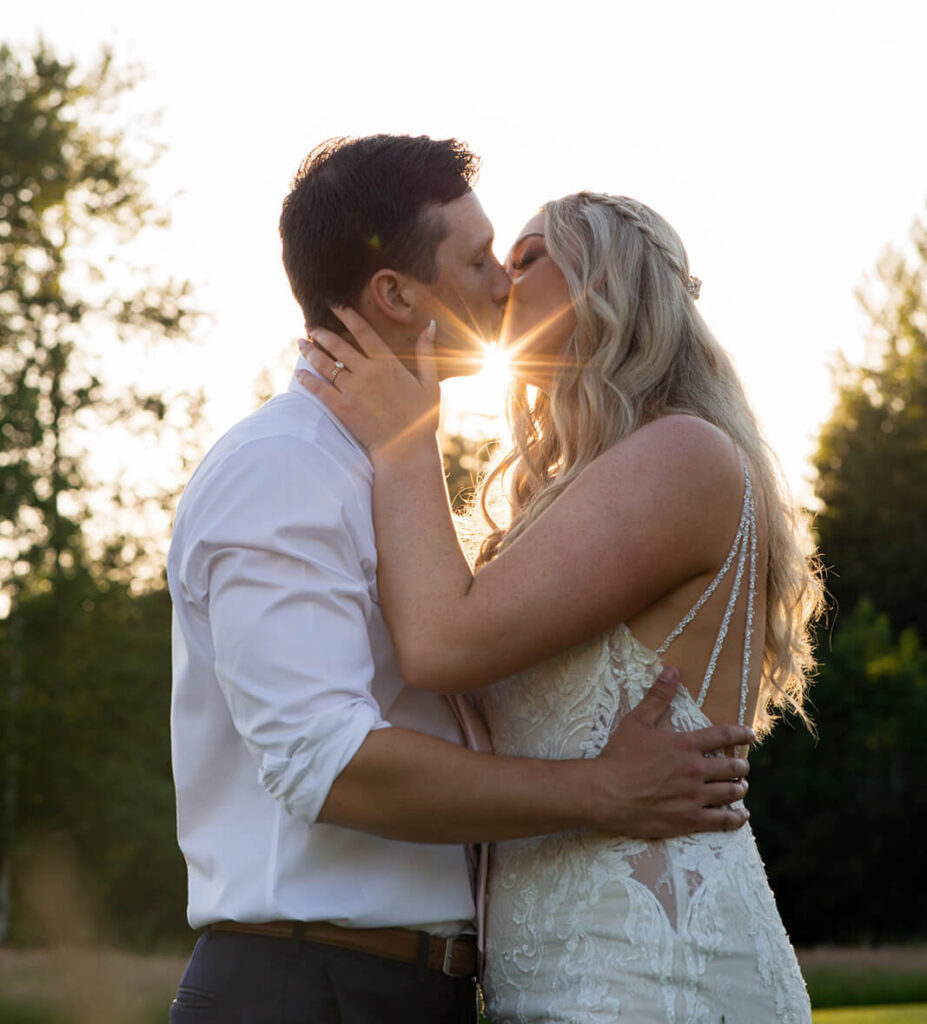Bride and groom kissing with sunshine at Mount Peak Farm