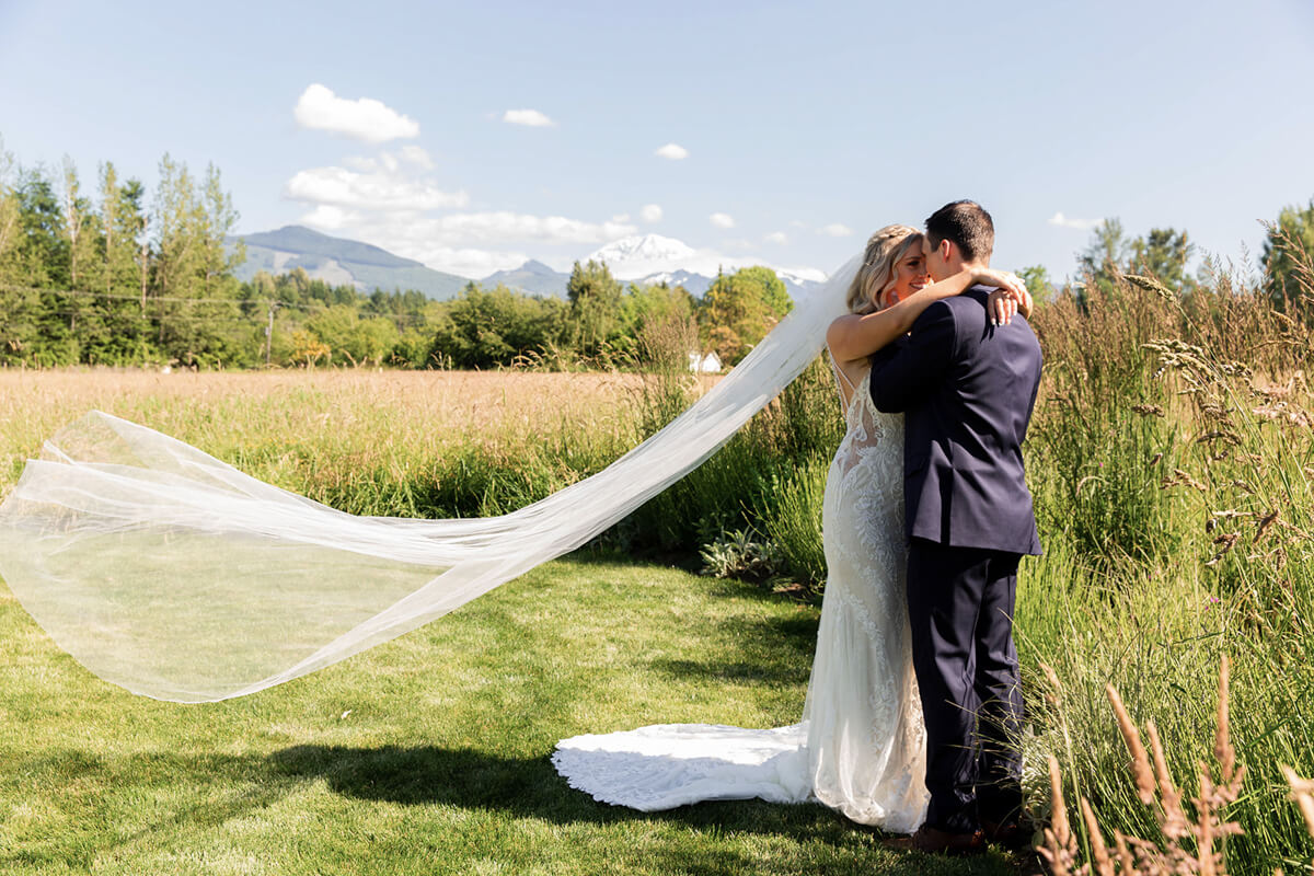 Bride and groom with floating veil at Mount Peak Farm