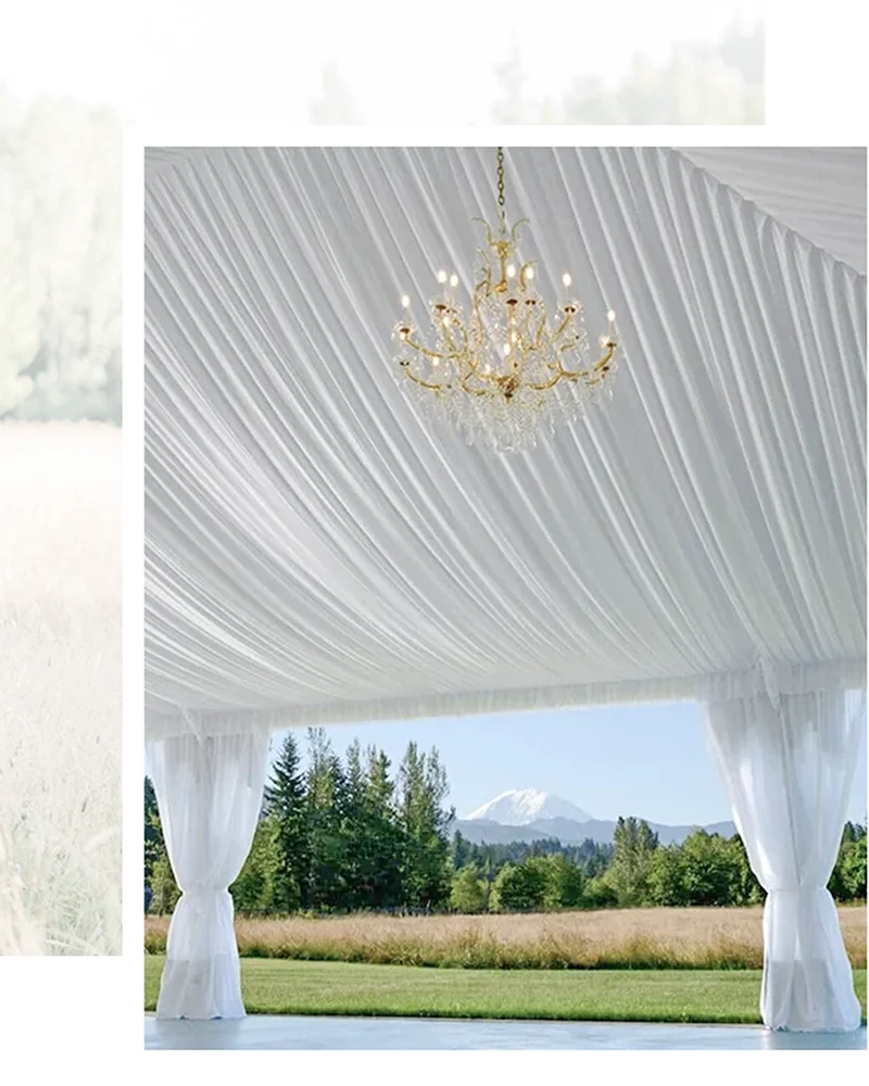 Reception tent with chrystal chandeliers with Mount Rainier view at Mount Peak Farm wedding venue.