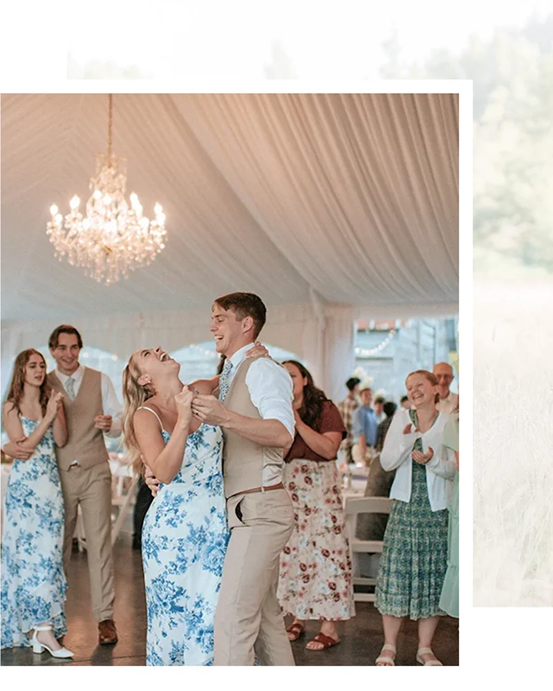 Bridesmaids and groomsman dancing in reception tent laughing